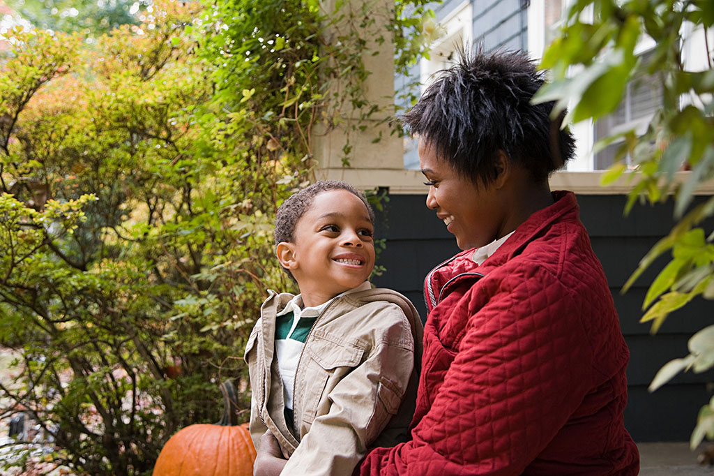 mother and son sitting on porch