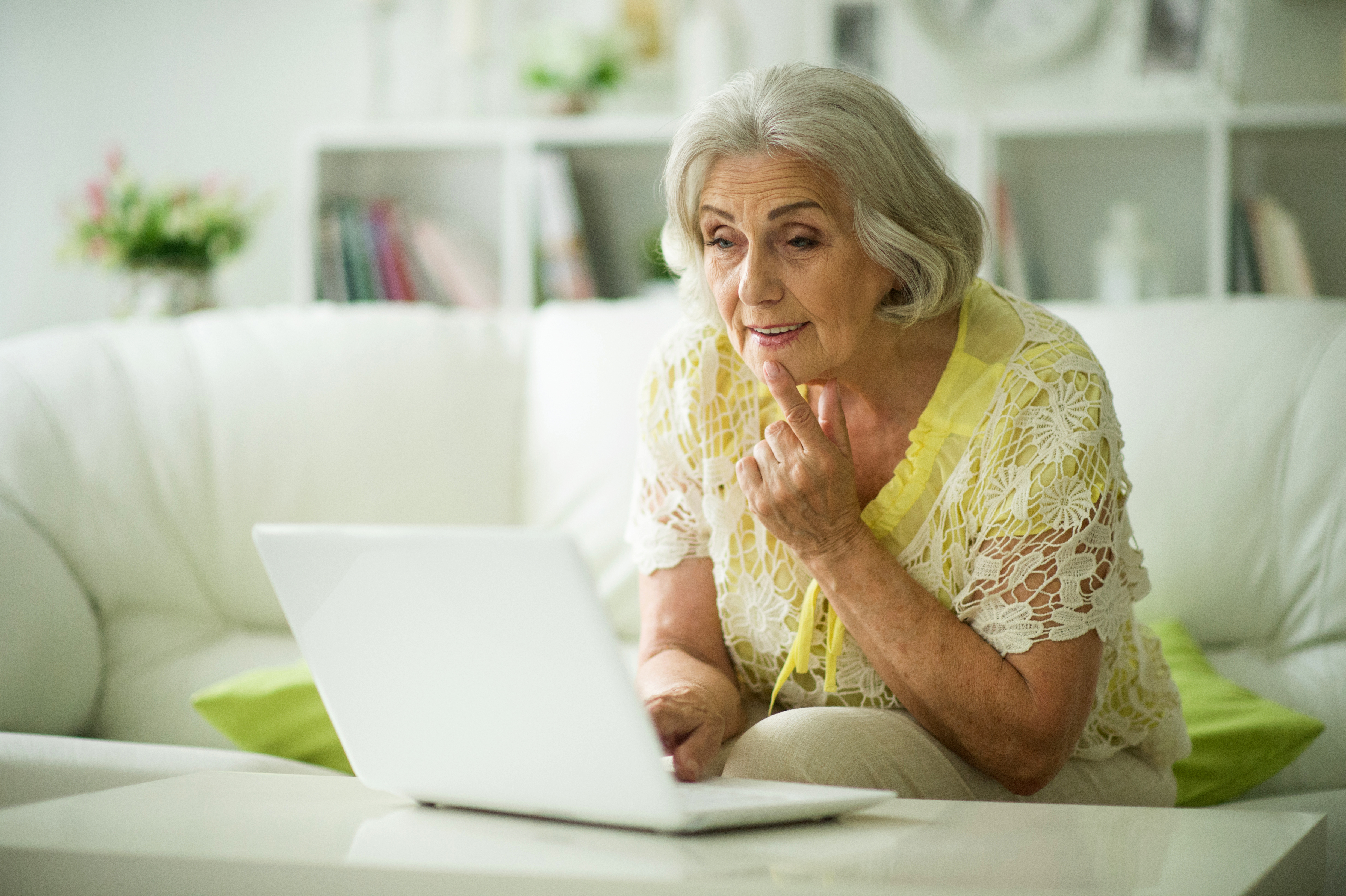 elderly womam looking at laptop