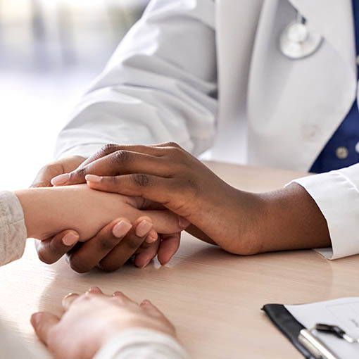 Critical Illness Insurance Doctor's hands holding patients for comfort